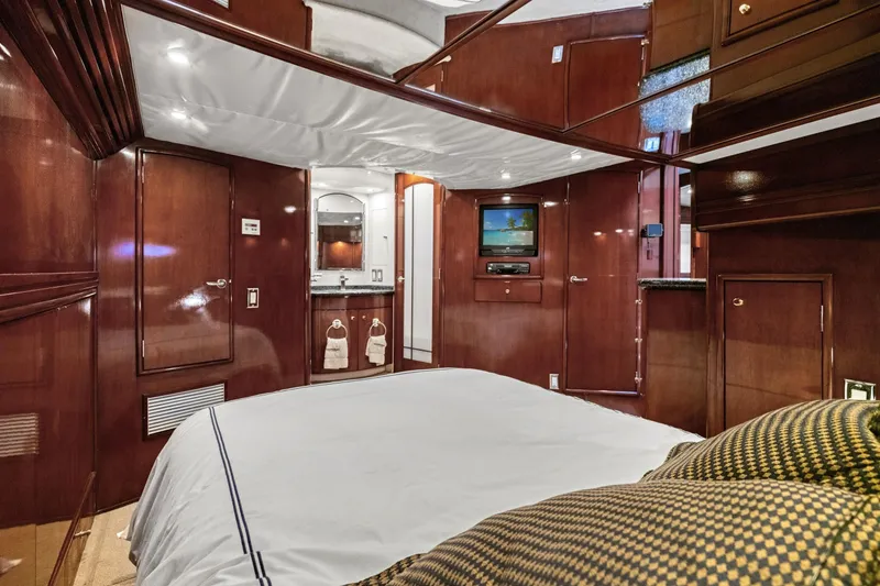 Slide: The Image of Luxurious interior of 1999 Carver 53 Voyager yacht with wood paneling and cozy bedding. - 20