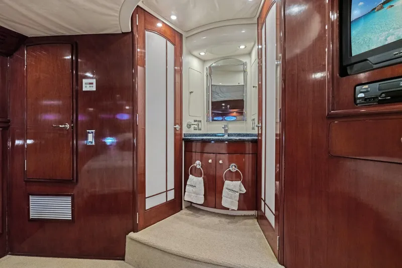 Slide: The Image of Luxurious interior of 1999 Carver 53 Voyager yacht with elegant wood finishes and modern amenities. - 21