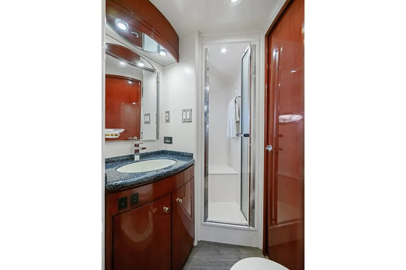 Slide: The Image of Luxurious bathroom in 1999 Carver 53 Voyager yacht with elegant wood cabinetry and modern fixtures. - 27