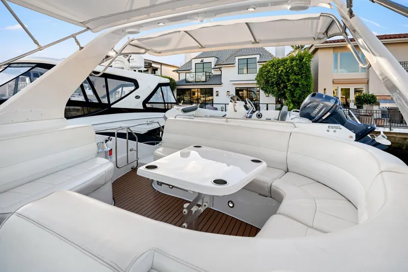 Slide: The Image of 1999 Carver 53 Voyager yacht with spacious white seating and table on deck. - 28
