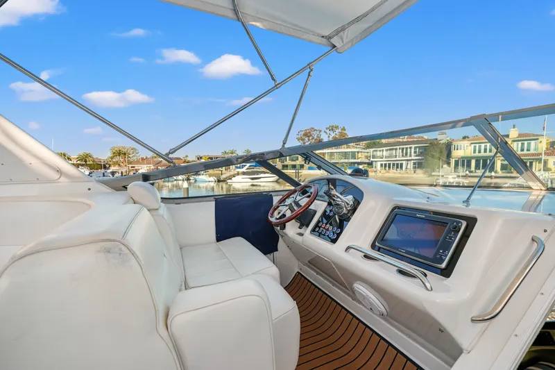 Slide: The Image of 1999 Carver 53 Voyager yacht helm with modern navigation system and waterfront view. - 31