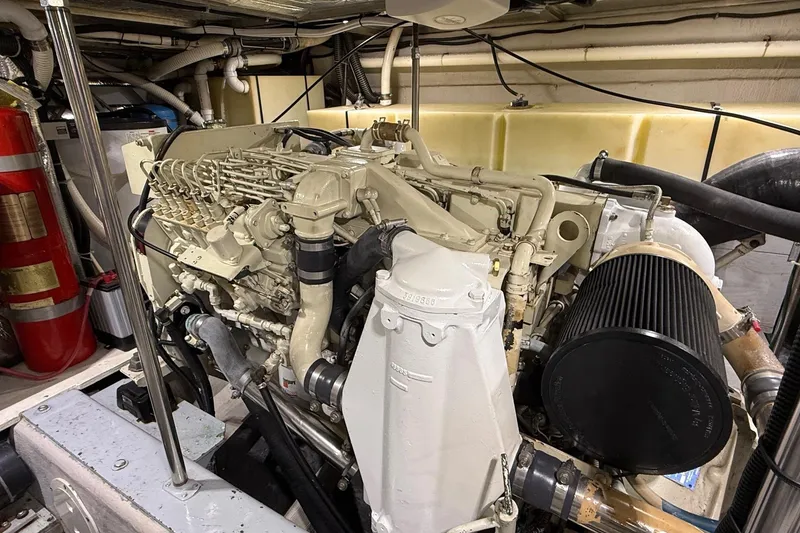 Slide: The Image of Engine room of 1999 Carver 53 Voyager yacht, showcasing detailed mechanical components. - 37