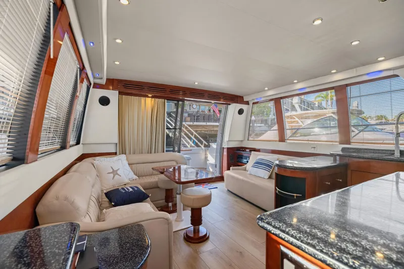 Slide: The Image of Luxurious interior of 1999 Carver 53 Voyager yacht with modern kitchen and wood finishes. - 8