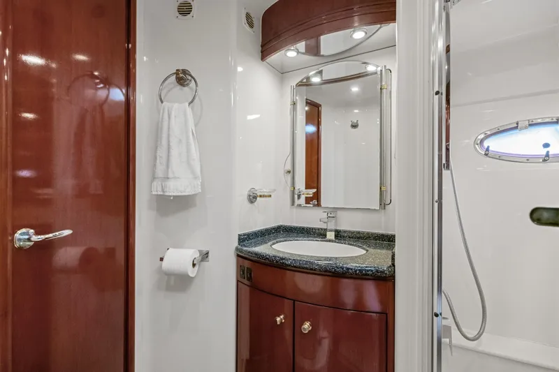 Slide: The Image of Luxurious bathroom in 1999 Carver 53 Voyager yacht with elegant wood cabinetry and modern fixtures. - 16