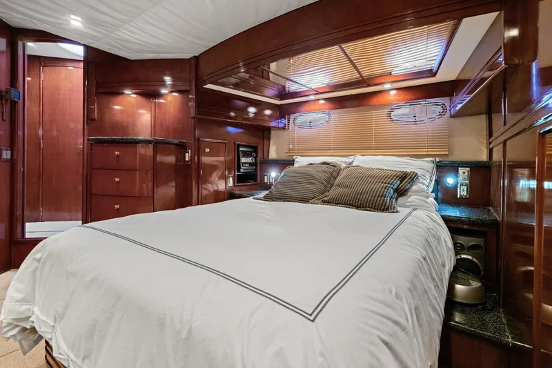 Slide: The Image of Luxurious bedroom interior of 1999 Carver 53 Voyager yacht with elegant wood finishes. - 17