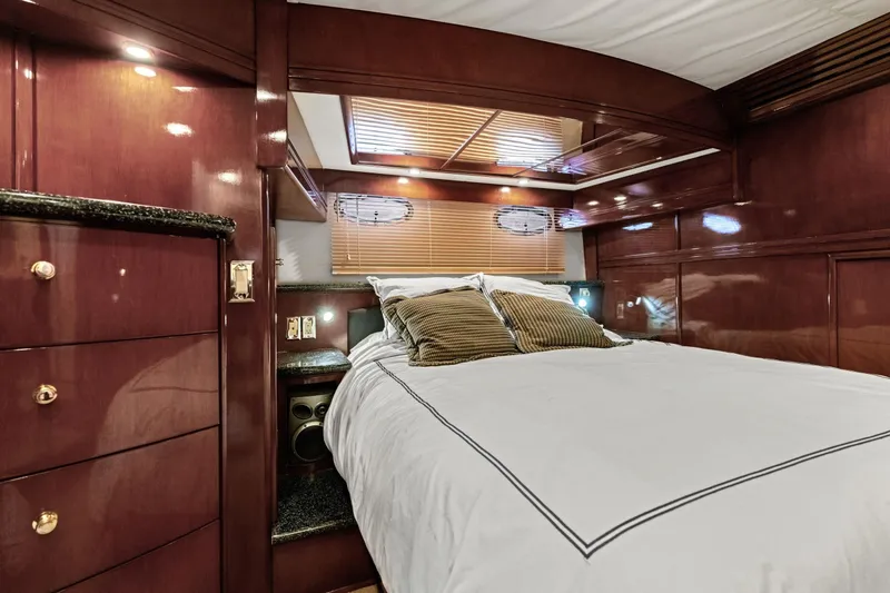 Slide: The Image of Luxurious bedroom interior of 1999 Carver 53 Voyager yacht with wood paneling and cozy bedding. - 22