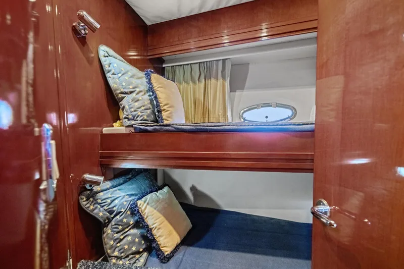 Slide: The Image of 1999 Carver 53 Voyager cabin with wooden interior and cozy bunk beds. - 24