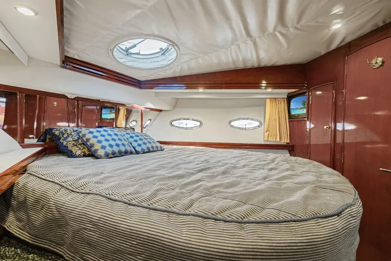 Slide: The Image of Luxurious cabin interior of 1999 Carver 53 Voyager yacht with plush bedding. - 25