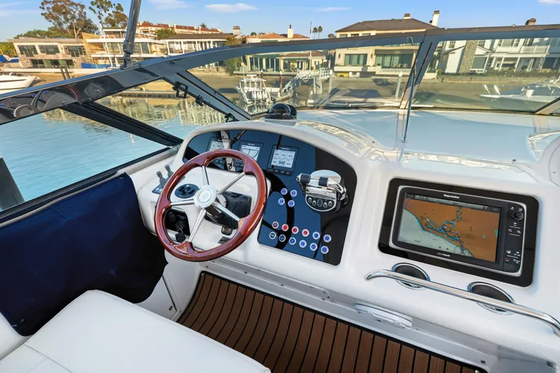 Slide: The Image of 1999 Carver 53 Voyager helm with navigation system and wooden steering wheel. - 32