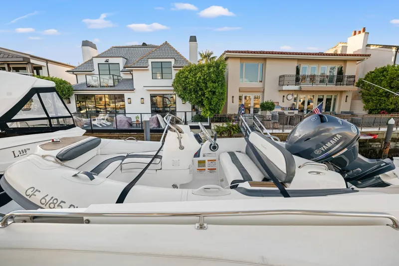 Slide: The Image of 1999 Carver 53 Voyager yacht docked near waterfront homes, featuring Yamaha engine. - 34