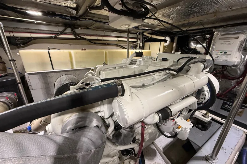 Slide: The Image of Engine room of a 1999 Carver 53 Voyager yacht, showcasing mechanical components. - 36