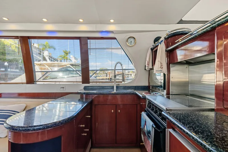 Slide: The Image of Luxurious interior of 1999 Carver 53 Voyager yacht with plush seating and elegant decor. - 5