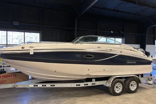 The Image of 2015 Hurricane SunDeck 2200 OB boat on trailer in indoor storage. - 0