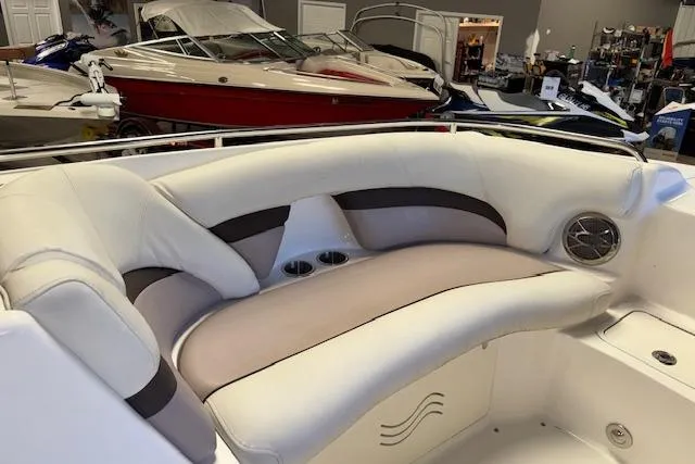 Slide: The Image of 2015 Hurricane SunDeck 2200 OB boat interior with white seating and cup holders. - 12