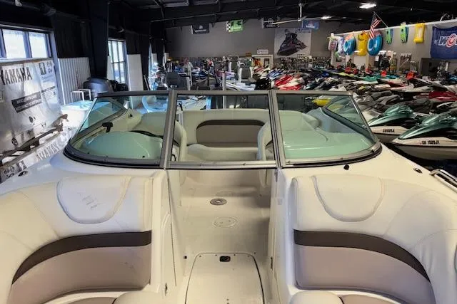 Slide: The Image of 2015 Hurricane SunDeck 2200 OB boat interior in showroom with various watercraft. - 14