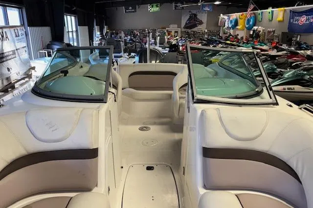 Slide: The Image of 2015 Hurricane SunDeck 2200 OB boat interior with seating and windshield in showroom. - 15