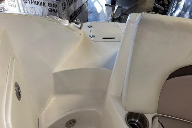 Slide: The Image of 2015 Hurricane SunDeck 2200 OB boat interior with seating and cup holder. - 19