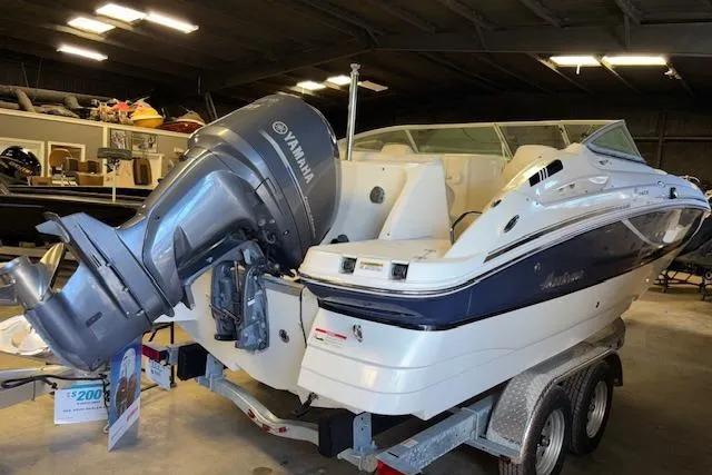 Slide: The Image of 2015 Hurricane SunDeck 2200 OB boat with Yamaha outboard motor on trailer in garage. - 2