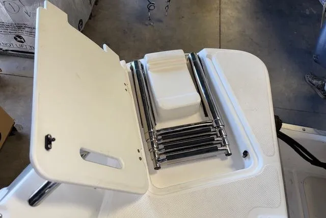 Slide: The Image of 2015 Hurricane SunDeck 2200 OB boat ladder compartment, open with stainless steel ladder. - 20