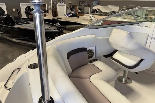 Slide: The Image of 2015 Hurricane SunDeck 2200 OB boat interior with white seating and steering area. - 21