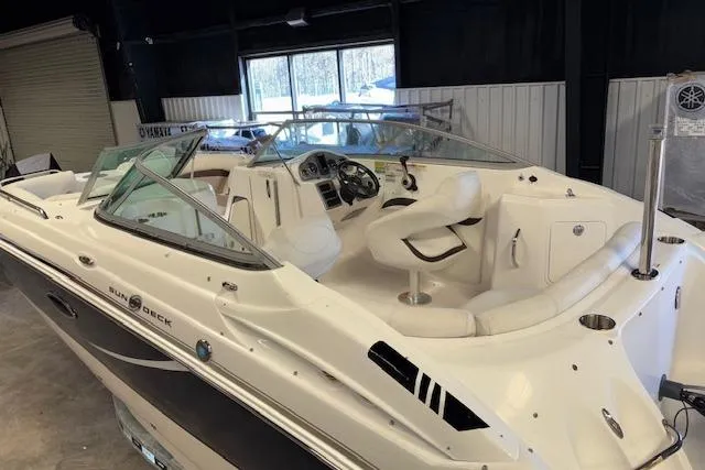 Slide: The Image of 2015 Hurricane SunDeck 2200 OB boat with white interior in a showroom. - 26