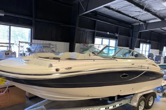 Slide: The Image of 2015 Hurricane SunDeck 2200 OB boat on trailer in indoor storage. - 3