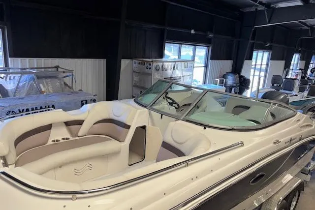 Slide: The Image of 2015 Hurricane SunDeck 2200 OB boat with spacious seating in a showroom. - 32
