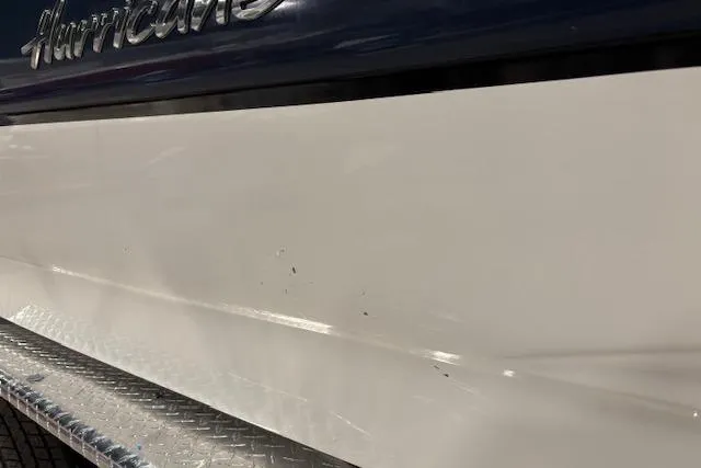 Slide: The Image of 2015 Hurricane SunDeck 2200 OB boat with minor scratches on the white hull. - 33