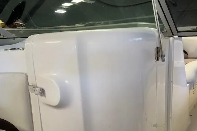 Slide: The Image of 2015 Hurricane SunDeck 2200 OB boat interior, featuring white paneling and seating. - 35