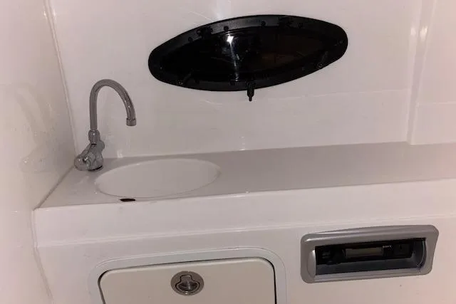 Slide: The Image of Interior sink area of 2015 Hurricane SunDeck 2200 OB boat with faucet and storage. - 37