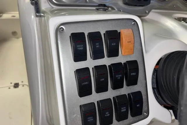 Slide: The Image of Control panel of a 2015 Hurricane SunDeck 2200 OB boat with labeled switches. - 43