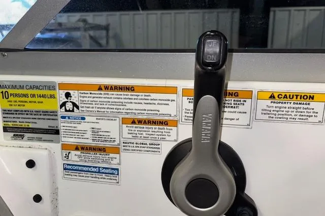 Slide: The Image of Control panel of 2015 Hurricane SunDeck 2200 OB with warning labels and capacity information. - 44