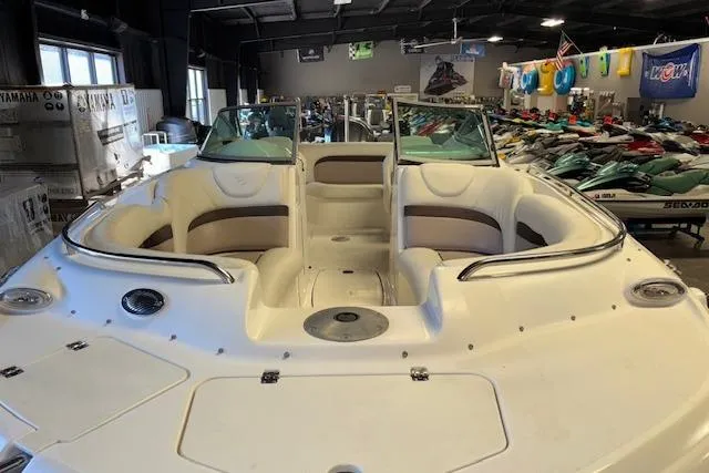 Slide: The Image of 2015 Hurricane SunDeck 2200 OB boat in showroom, featuring spacious seating and sleek design. - 7