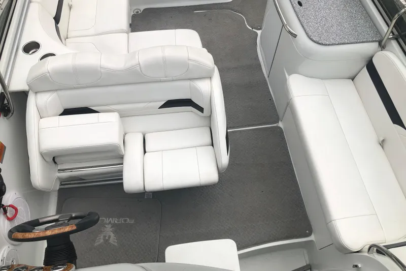 Slide: The Image of 2007 Formula 260 Sun Sport boat interior with white seating and steering wheel. - 13