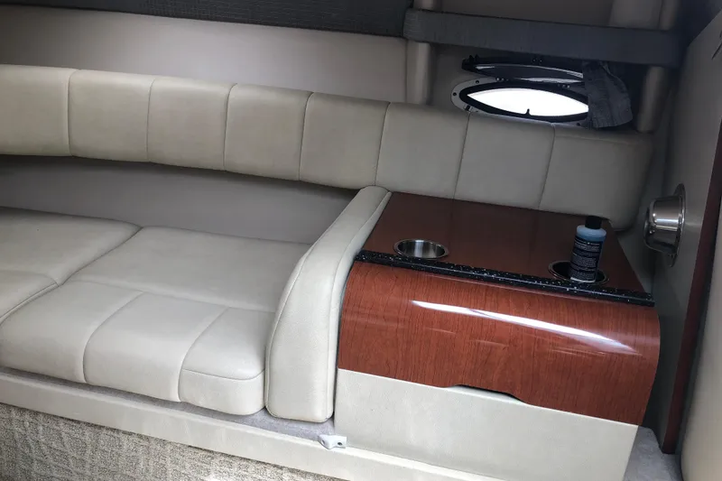 Slide: The Image of Interior of 2007 Formula 260 Sun Sport boat with beige seating and wooden table. - 17