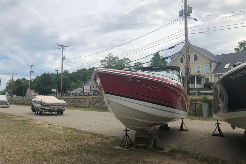 Slide: The Image of 2007 Formula 260 Sun Sport boat on stands near residential area. - 4