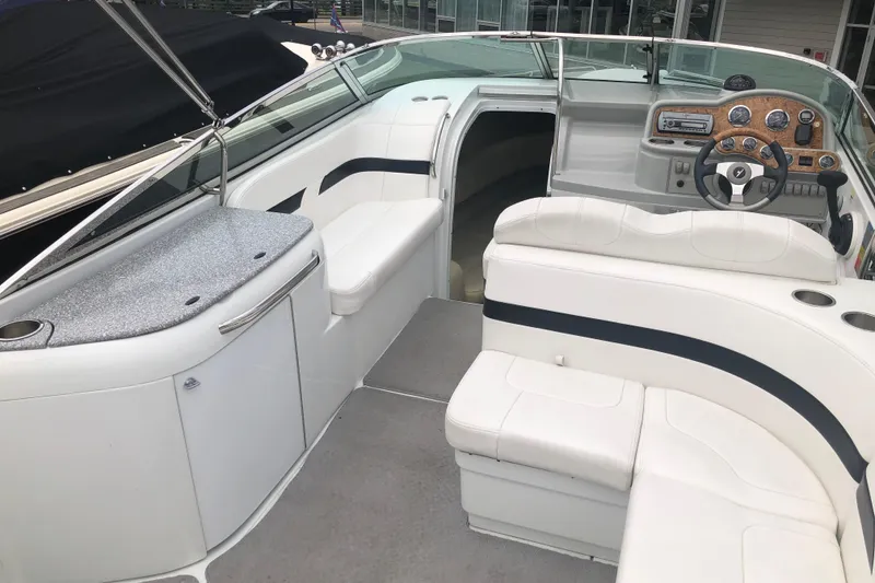 Slide: The Image of 2007 Formula 260 Sun Sport boat interior with white seating and modern dashboard. - 8