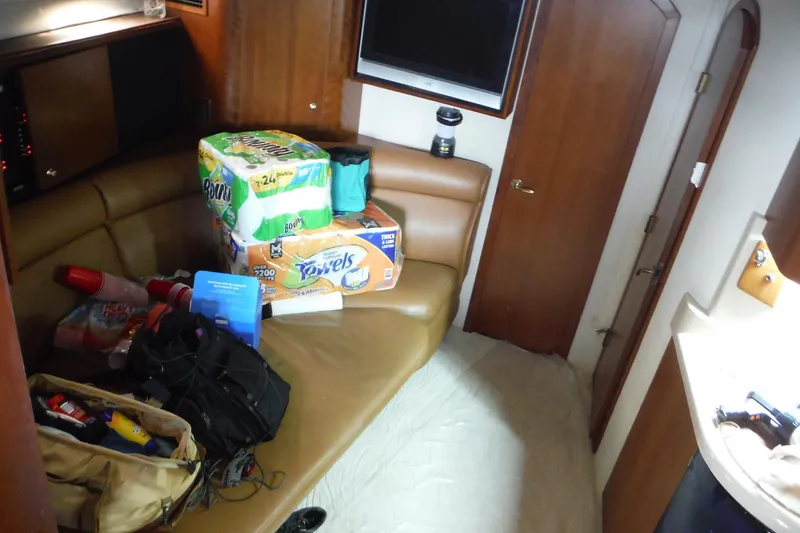 Slide: The Image of 1999 Cruisers 4270 Express cabin interior with supplies and seating area. - 12