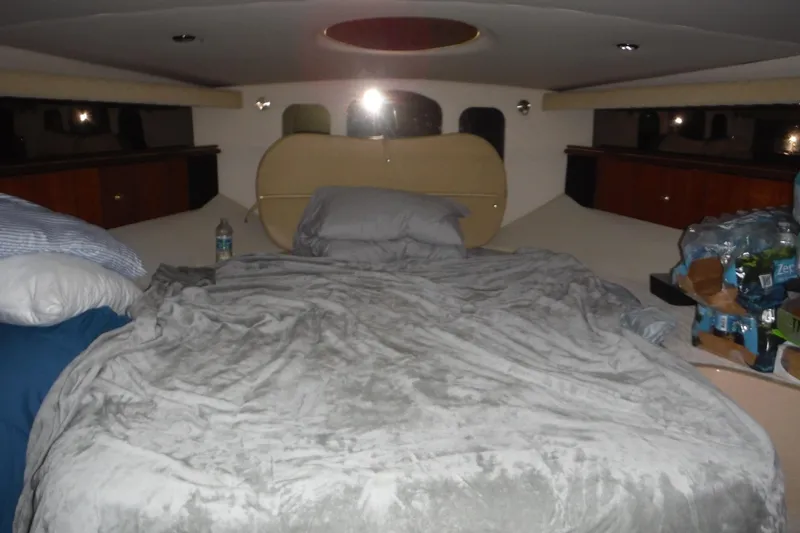 Slide: The Image of 1999 Cruisers 4270 Express cabin interior with bed and storage space. - 15
