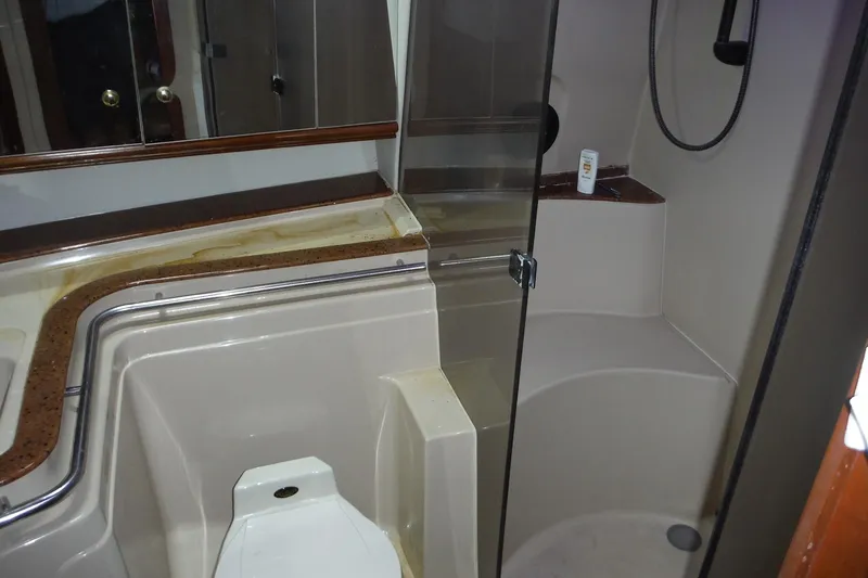 Slide: The Image of 1999 Cruisers 4270 Express yacht bathroom with shower and toilet. - 16
