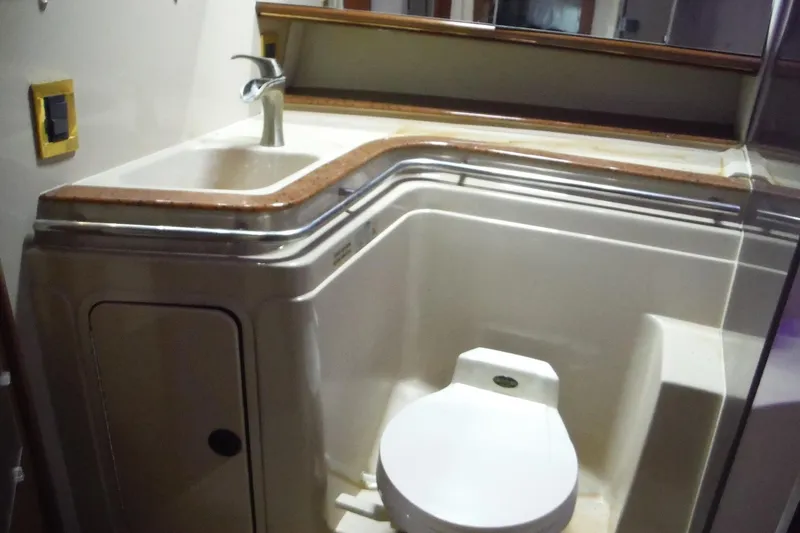 Slide: The Image of 1999 Cruisers 4270 Express yacht bathroom with sink and toilet. - 17