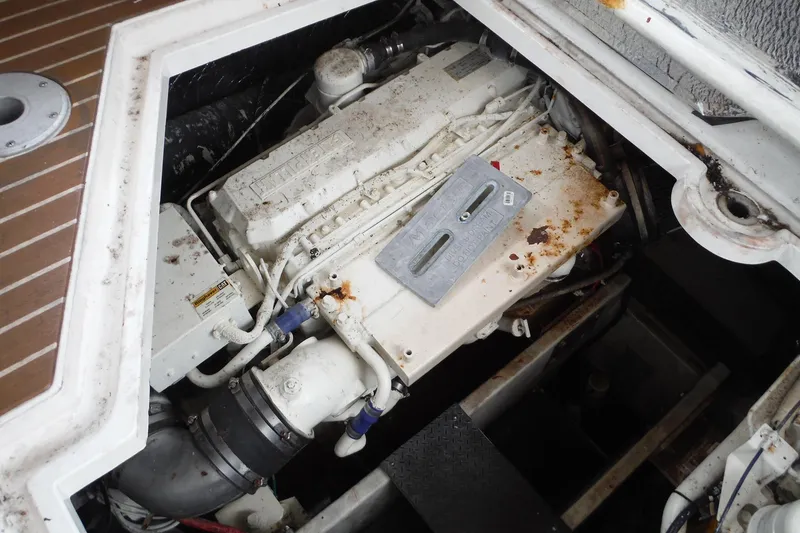 Slide: The Image of 1999 Cruisers 4270 Express engine compartment with visible wear and rust. - 31