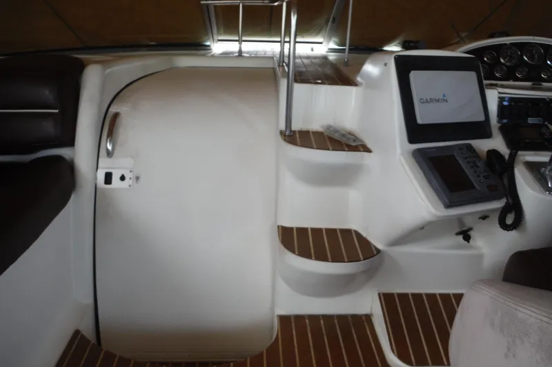 Slide: The Image of 1999 Cruisers 4270 Express cockpit with Garmin navigation system and wooden steps. - 34