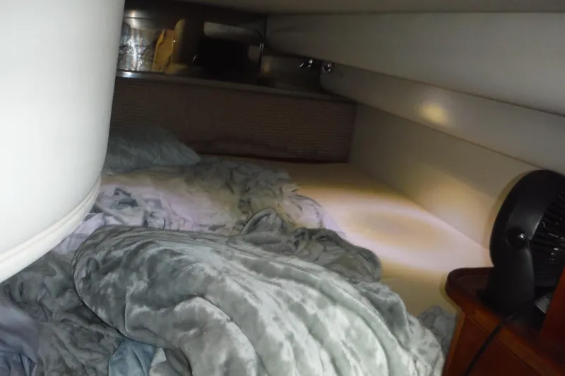 Slide: The Image of Cozy cabin interior of 1999 Cruisers 4270 Express with bedding and fan. - 39