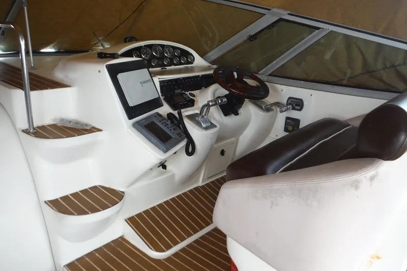 Slide: The Image of 1999 Cruisers 4270 Express helm with steering wheel, controls, and navigation equipment. - 8
