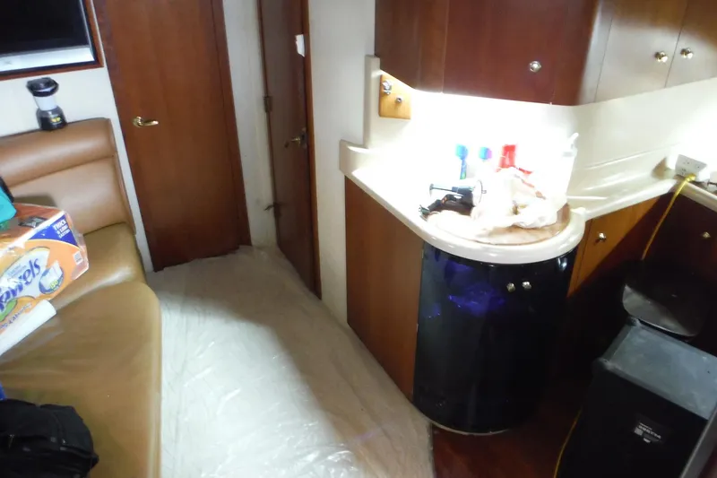 Slide: The Image of Interior of 1999 Cruisers 4270 Express yacht with kitchen and seating area. - 13
