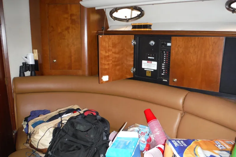 Slide: The Image of 1999 Cruisers 4270 Express cabin interior with seating, storage, and electrical panel. - 18