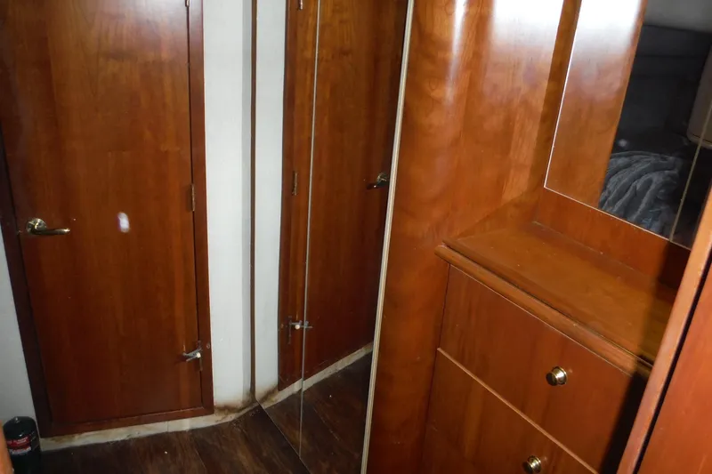 Slide: The Image of 1999 Cruisers 4270 Express interior with wooden cabinetry and mirrored closet. - 21