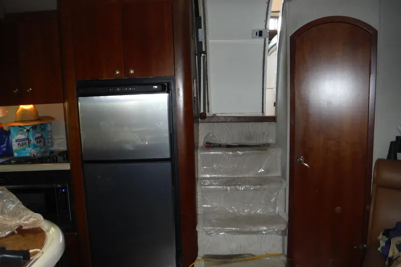Slide: The Image of Interior of 1999 Cruisers 4270 Express with kitchen and stairs. - 26