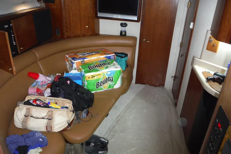 Slide: The Image of 1999 Cruisers 4270 Express cabin interior with supplies and seating area. - 27